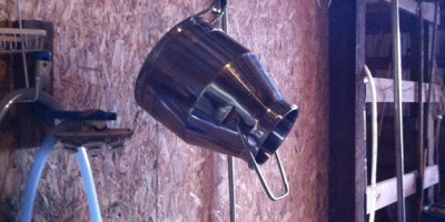 Milking jug hung over "clean" milking station.