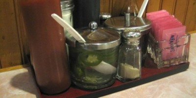 Tray of accoutrements for Phở (Vietnamese noodle soup) including a shaker of the infamous Lian How white pepper.