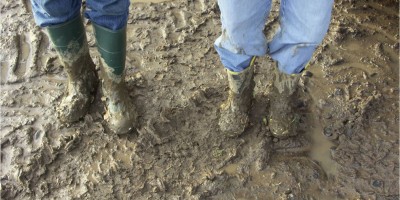 A picture of muddy boots with the caption Another day in the life of a field epidemiologist.