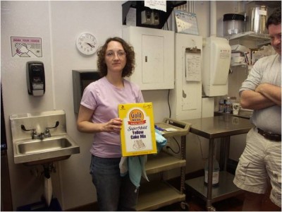 Melissa Plantega holding a box of cake mix at a Cold Stone Creamery store in Tigard, OR.