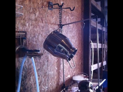 Milking jug hung to air-dry over "clean" milking station.