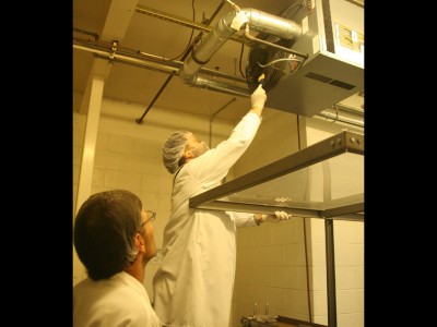 Epidemiologists swab ceiling vents as they search for clues about whether Salmonella is contaminating this milk product.